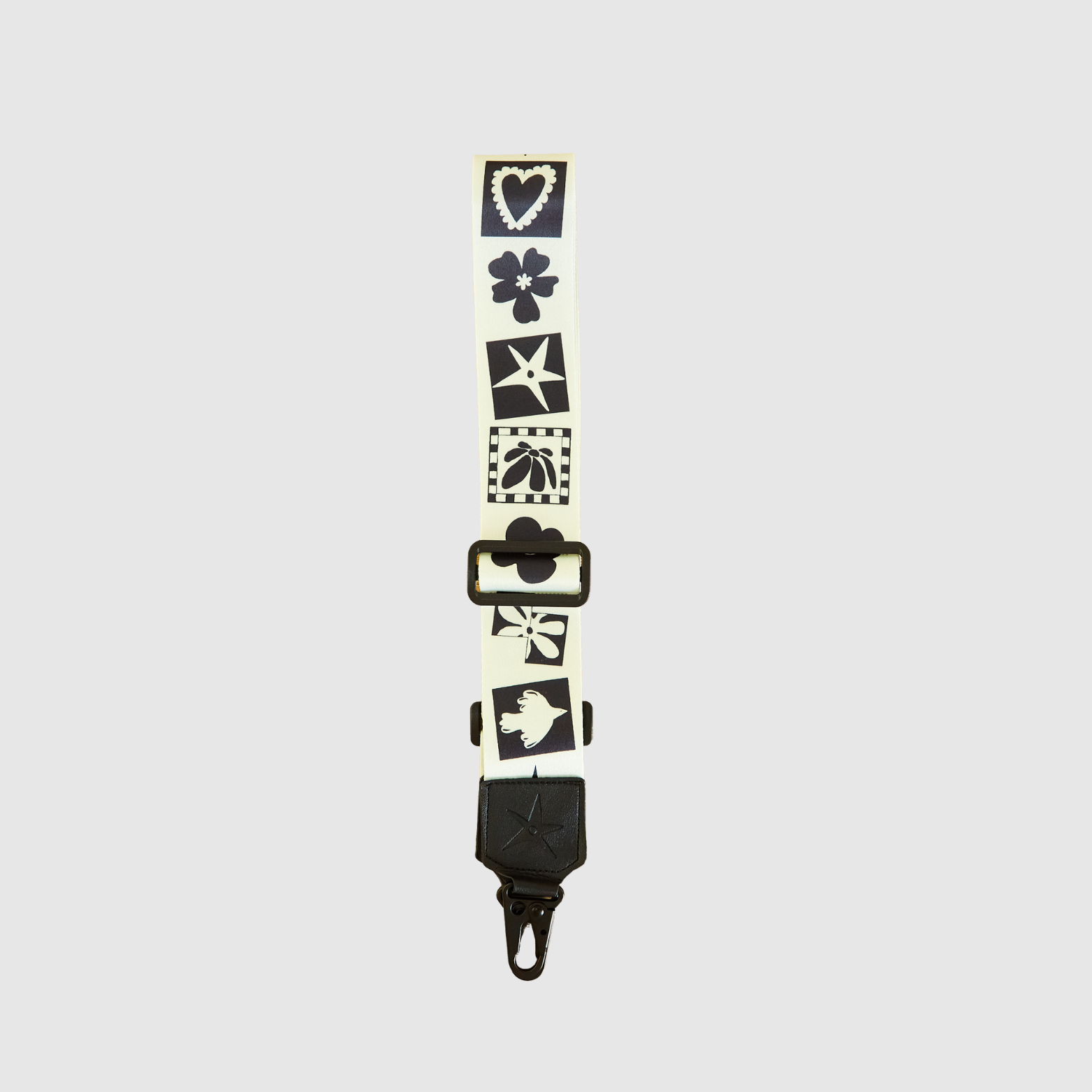 THE OG Strappi strap styled with a camera, showing length and attachment clips